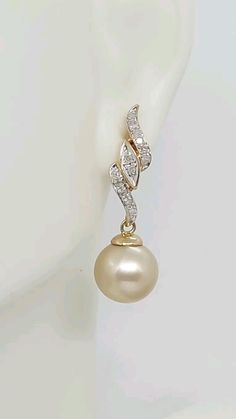 GOLDEN South Sea 8mm Round Cultured Pearl Yellow Gold Diamonds Earring. Push back Solid 14K Yellow Gold South Sea Pearl Earrin. Pearl Long Earrings. Gift for her. South Sea Pearl LOVER. Available on Etsy.com Store name AmazingbyAlexander. https://amazingbyalexander.etsy.com/listing/1160203027 Product Info: - Stone: Golden South Sea/Diamonds - Pearls Size: 8mm - Diamonds Quantity: 26 - Earring dimensions: 30mm Long. - Metal: 14k. - Finish: Yellow Solid Gold. - Handmade item. - Made in USA. - Nice Gift box is included. Gold Pearl Earrings With Prong Setting In 14k Gold, Pearl Long Earrings, South Sea Pearls Earrings, Yellow Gold Diamond Earrings, Long Pearl Earrings, Sea Pearl, Gold Diamond Earrings, Sea Pearls, South Sea Pearls