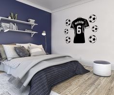 a bedroom with a soccer jersey wall decal on the wall and shelves above it