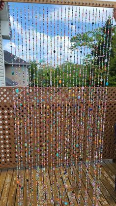 a wooden deck with beads hanging from it