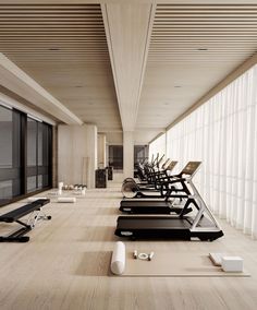 there are many treadmills lined up on the floor near each other in this room