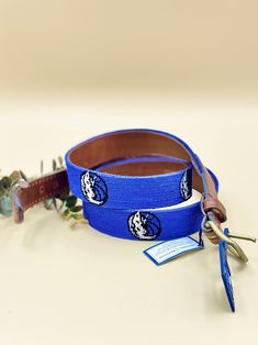 Needlepoint blue belt with Dallas Mavericks design. This royal blue belt is made by Smathers & Branson and is 44" inch size. The body side and ends are Italian tanned leather and it's got a high quality solid brass buckle. Beautiful unique statement piece. The inside of the leather part has light surface stcratches and a small faint sharpie park- please look at the photos for more details. The belt is in new condition, with tags. Please message with any questions, Thank you Royal Blue Belt, Blue Belt, Belt Leather, Dallas Mavericks, Brass Buckle, Suspender Belt, Suspenders, Needlepoint, Solid Brass