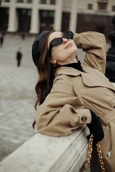 a woman with her eyes closed sitting on a bench