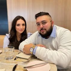 a man and woman sitting at a table