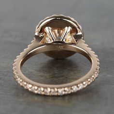 a close up view of an engagement ring with diamonds on the band and side stones