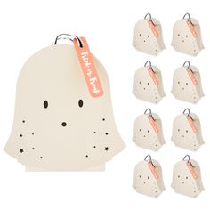 a bunch of little white tags with faces on them