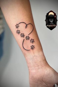 a person with a tattoo on their arm and paw prints in the shape of a heart