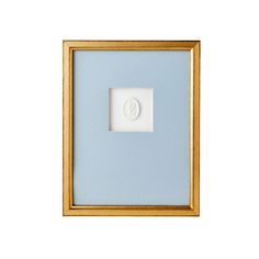 a white and gold framed object with a light blue background