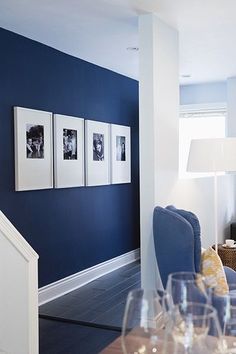 a room with blue walls and pictures on the wall