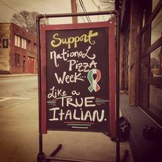 a sign on the side of a building that says support national pizza week like a true italian