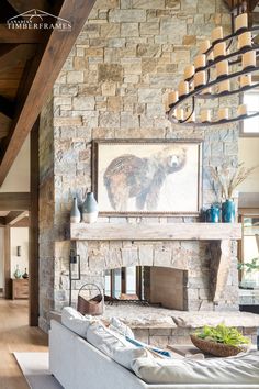 a living room with stone fireplace and large painting on the wall