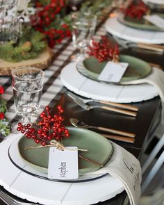 the table is set with plates and place settings