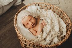 a newborn baby is sleeping in a basket