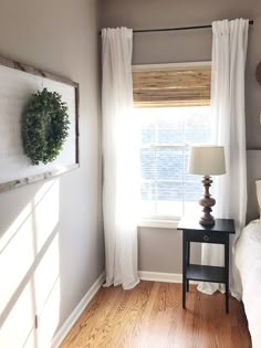 a bed room with a neatly made bed and a window