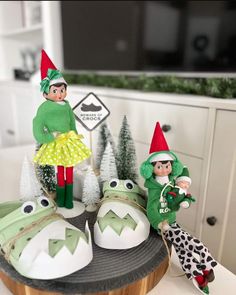 two elfs are sitting on top of some shoes