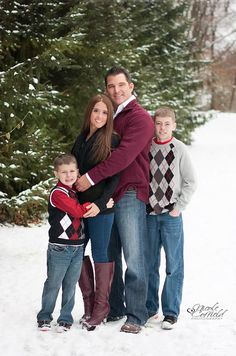 a family posing for a photo in the snow