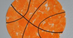 an orange basketball painted on the side of a white wall with black lines in it