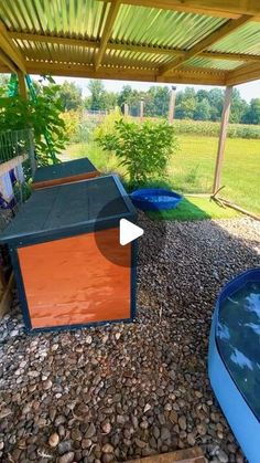 an outdoor hot tub in the middle of a yard with rocks and gravel around it