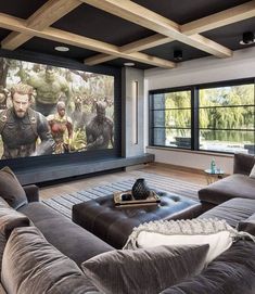 a living room with couches and a large screen