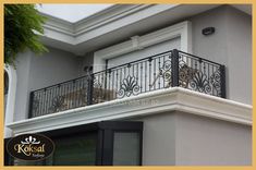 a balcony with wrought iron railings and a cat sitting on the balconies