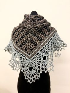 a crocheted shawl on a mannequin head