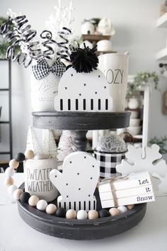 a black and white christmas tree with ornaments on it's sides, all decorated in different shapes and sizes