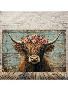 a painting of a cow with flowers on it's head, sitting in front of a brick wall