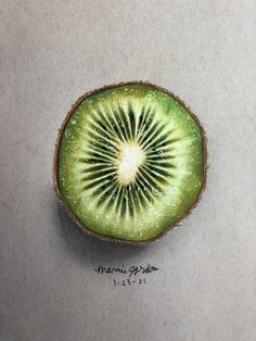 a kiwi cut in half sitting on top of a table