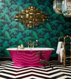 a bathroom with a pink bathtub and gold fixtures