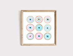 an art print with pink and blue donuts on it