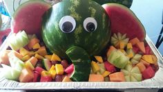 an elephant made out of watermelon, apples and melons in the shape of elephants