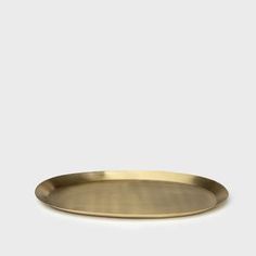 a brass plate on a white background with no one in the room to see it