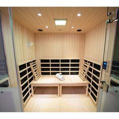 the inside of a sauna with benches and lights