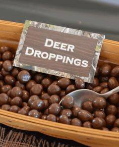 a basket filled with chocolate candies and a sign that says deer droppings on it