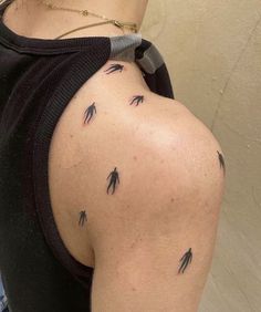 the back of a woman's shoulder with arrows on it