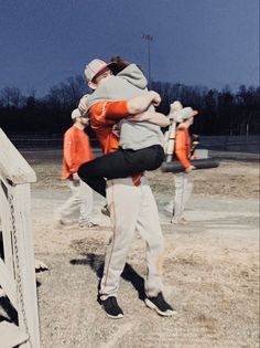 the baseball players are hugging each other on the field