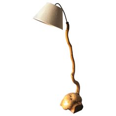 a wooden lamp with a white shade on it's head and neck is shown against a white background