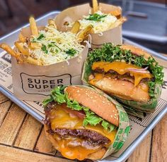 two cheeseburgers and fries on a tray