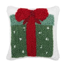 a green and red pillow with a bow on it