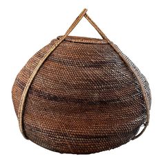 a round basket made out of woven material with a handle on the front and side