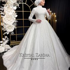 a woman in a white wedding dress standing next to a floral arch