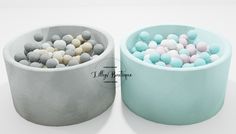 two bowls filled with different colored balls on top of each other and one is empty