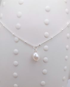 "Sterling silver dainty pearl necklace. This sterling silver necklace has a pretty satellite chain with  freshwater rice pearl.  Necklace length 16\".  Freshwater pearl approx 6mm by 8mm. Matching items available at https://everythingpearlsuk.etsy.com/listing/1575573474 All our jewellery comes with a gift box or velvet gift pouch ready for gifting, which is also perfect for storing your jewellery. Please note that all earrings are non-refundable for health and safety reasons.  However, if you ha White Dainty Pearl Necklace With Satellite Chain, Dainty White Pearl Necklace With Satellite Chain, Delicate White Pearl Necklace With Satellite Chain, White Pearl Necklace With Satellite Chain, Pearl Satellite Chain Necklace As Gift, Pearl Necklace With Satellite Chain As Gift, Silver Wedding Necklaces With Satellite Chain, Silver Satellite Chain Necklace For Wedding, Silver Wedding Necklace With Satellite Chain