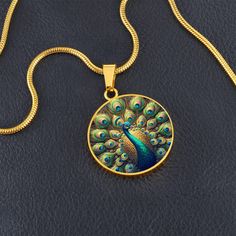 Admire the elegance of the Radiant Peacock Pendant Necklace, featuring a breathtaking stained glass style illustration of a peacock in full feather display. This intricate design showcases the peacock's vibrant plumage with stunning detail, capturing the essence of its regal beauty. Forged from premium surgical steel and available with a lavish 18k gold finish, this innovative jewelry boasts our exclusive design, handcrafted with care right here in the U.S.A by our dedicated team of skilled work Peacock Design Jewelry Gift, Peacock Design Jewelry For Gifts, Peacock Design Jewelry As Gift, Peacock Design Pendant Necklace Gift, Peacock Design Pendant Necklace As Gift, Round Peacock Design Jewelry Gift, Spiritual Jewelry With Peacock Design As A Gift, Spiritual Peacock Design Jewelry As Gift, Feather Display