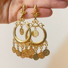 Hi there! A fine set of earrings from the Arabian heritage. 21K gold plated with coins. Wear it to your photoshoot, henna party, or as a wedding guest. Or on Eid! This piece falls under the category of gold imitation. It has the same design as real gold pieces sold in the Middle East. Enjoy it! Since this piece is gold plated, please wear it gently as its color should last you much more than any other piece of jewelry. Please avoid washing or scratching the plating away, and keep out of contact with creams and perfumes.  Any question? Want this as a gift to someone? Please message me! I will be very happy to help. Since I am just starting off this business, please know that no returns, refunds, or cancellations will be supported. Thanks for your understanding! Gold Earrings Arabic Design, Arab Earrings, Arabian Jewelry Gold, Gold Jewelry Middle East, Arabian Earrings, Middle Eastern Earrings, Arabic Earrings, Arabic Jewelry Traditional Gold, Middle Eastern Earrings Gold