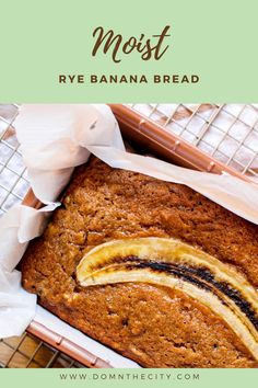 a loaf of banana bread on top of a cooling rack with the words, most rye banana bread