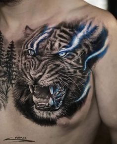 a man's chest with a tiger and pine tree tattoo on it, which is painted in blue