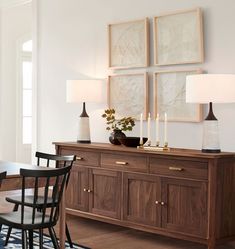 a dining room table with chairs and lamps