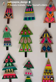 paper christmas trees are hanging on the wall