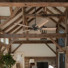 a living room with wooden beams and a ceiling fan