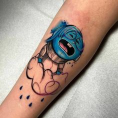 a cartoon character tattoo on the arm